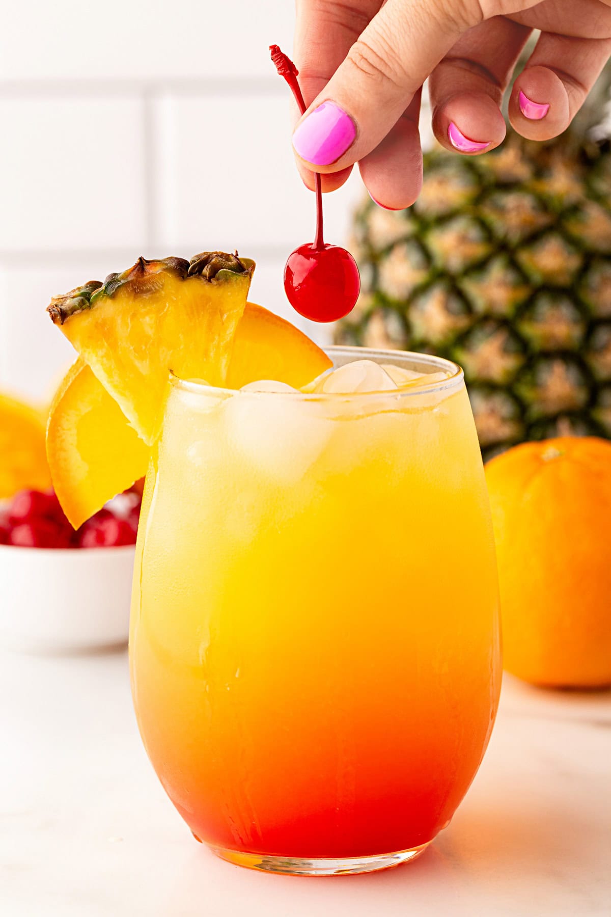 Garnished with orange and pineapple slice and a cherry.
