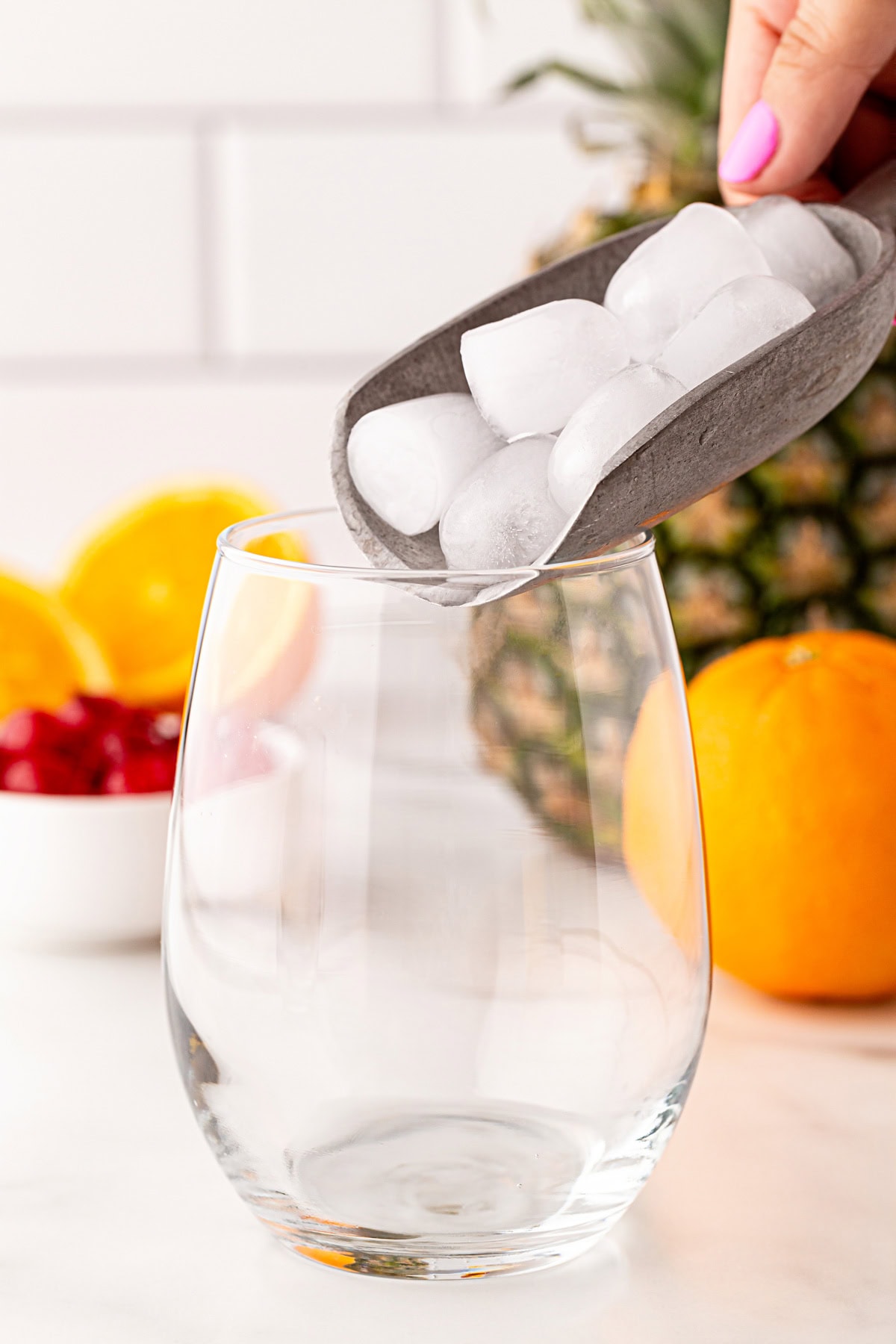 Adding ice to a glass.