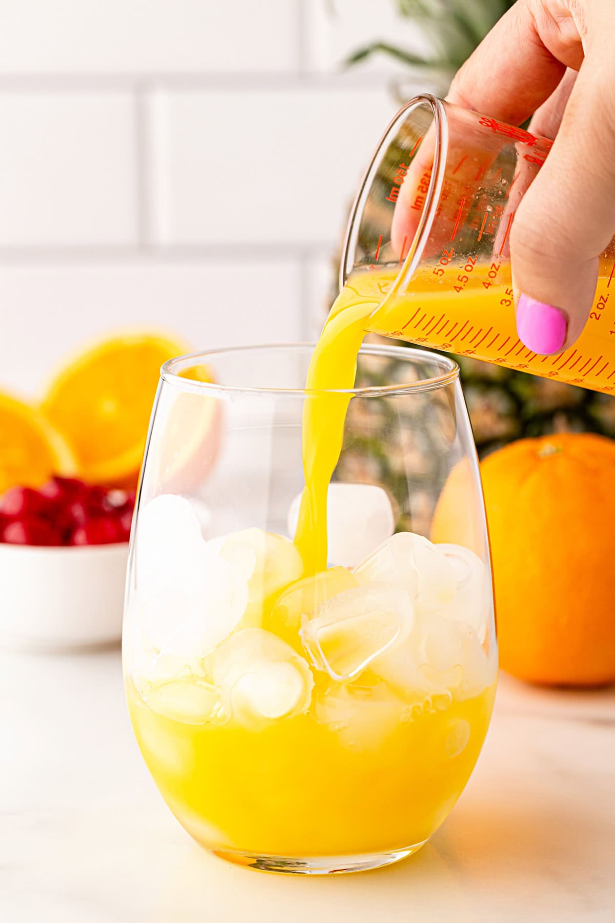 Adding orange juice.