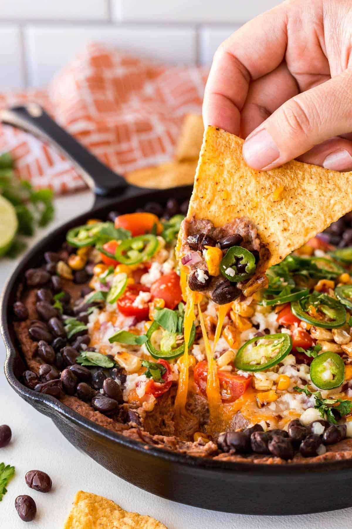 Taking a scoop of black bean dip. 