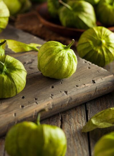 Tomatillos on a wood board.