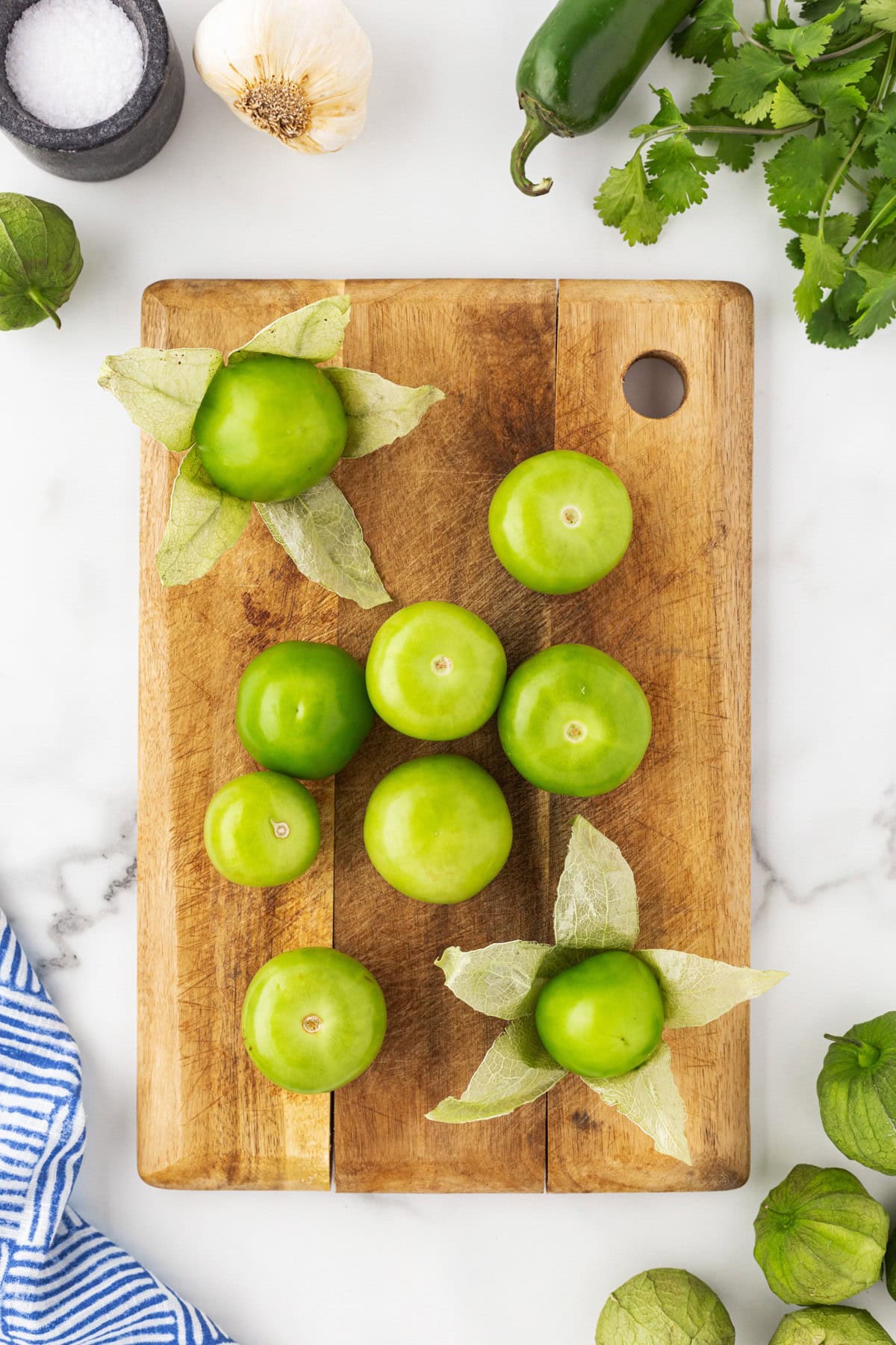 Tomatillos on a cutting board.