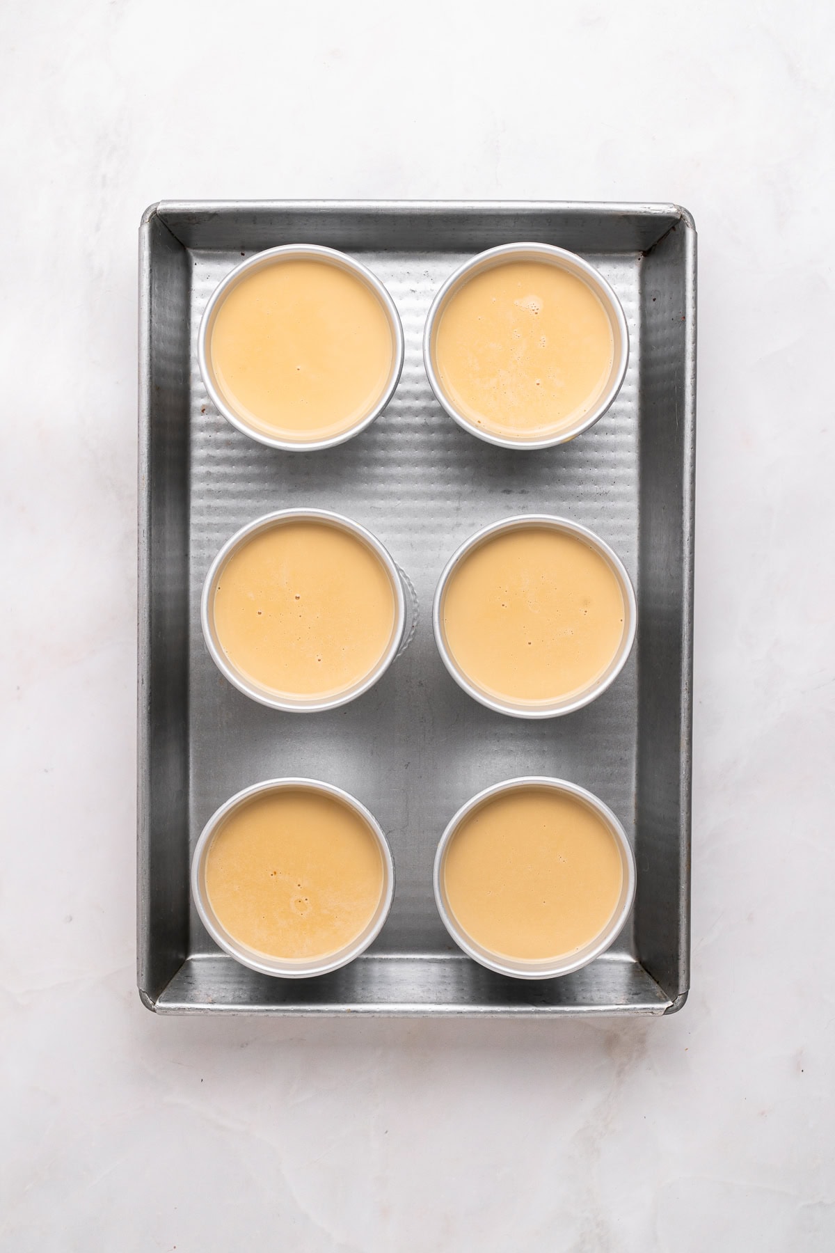 Filled panna cotta molds.