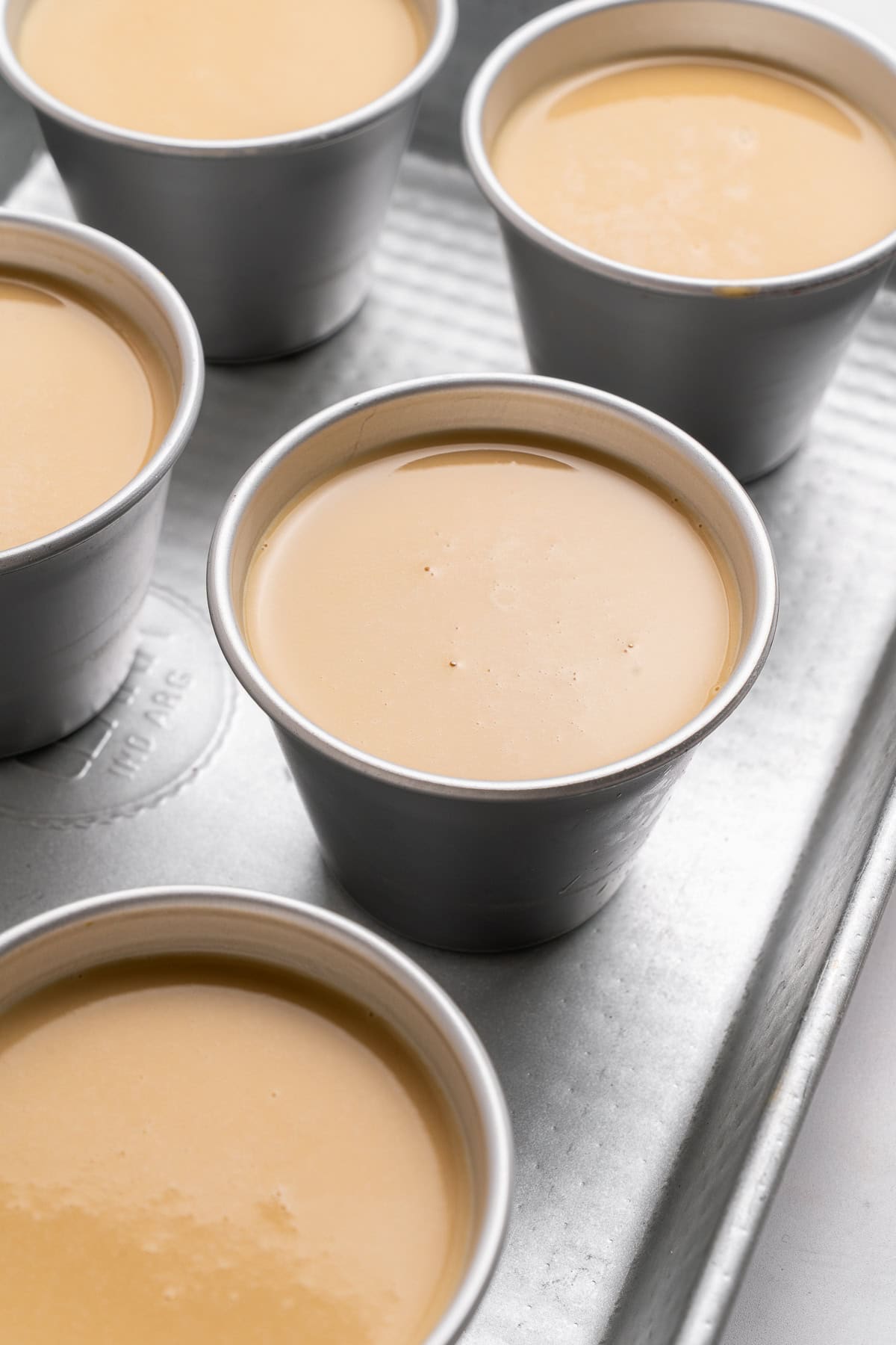 Close-up on panna cotta molds.