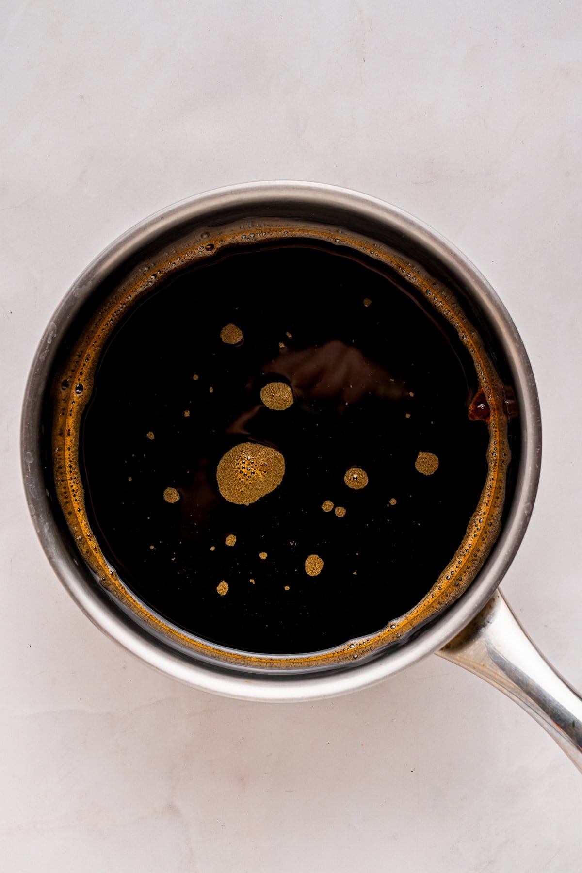 Coffee syrup in a saucepan.