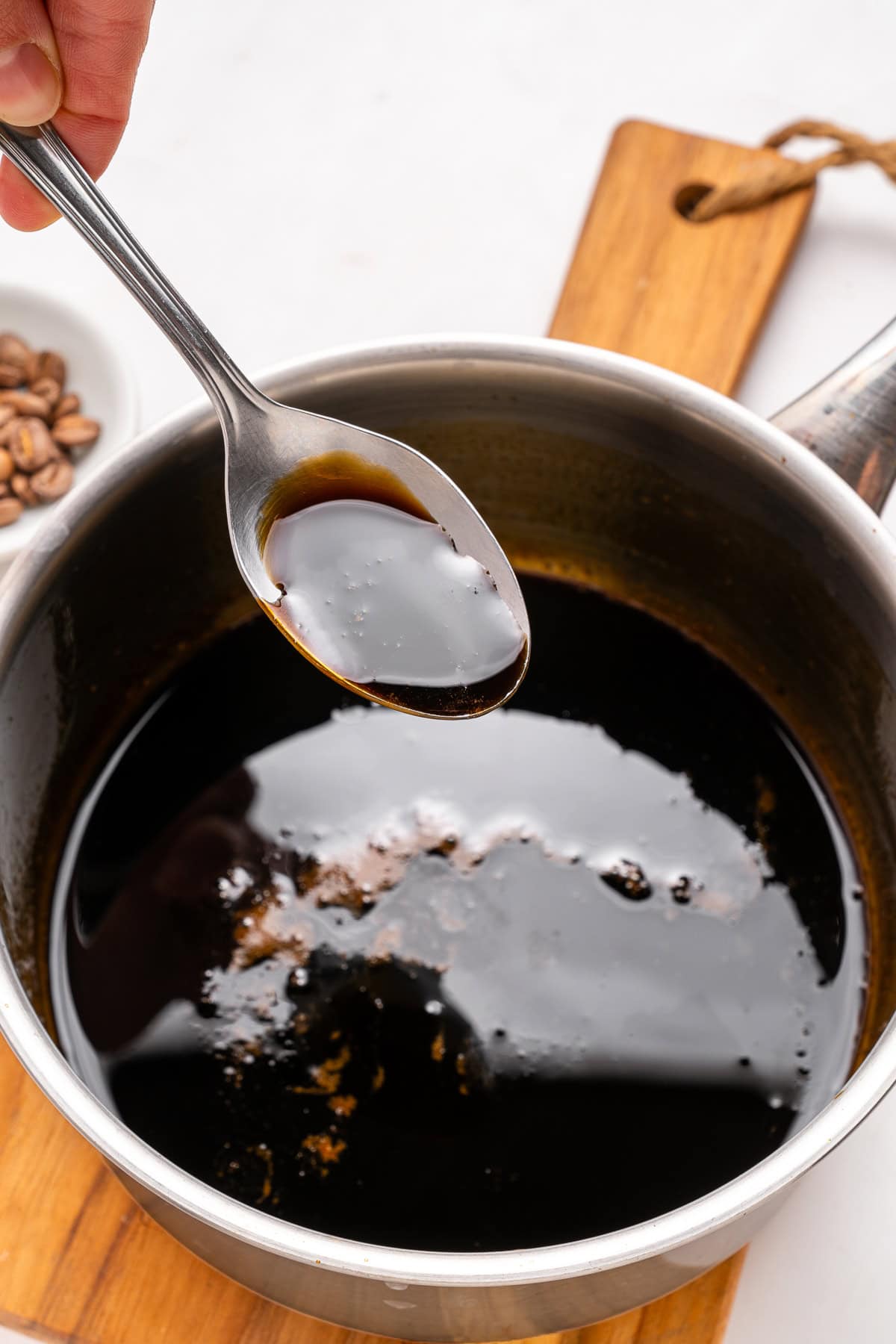 Spooning coffee syrup.