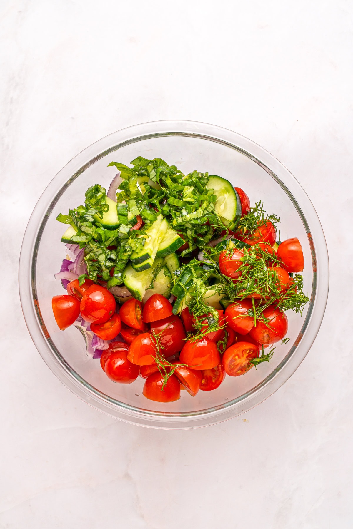 Chopped herbs over tomato salad.