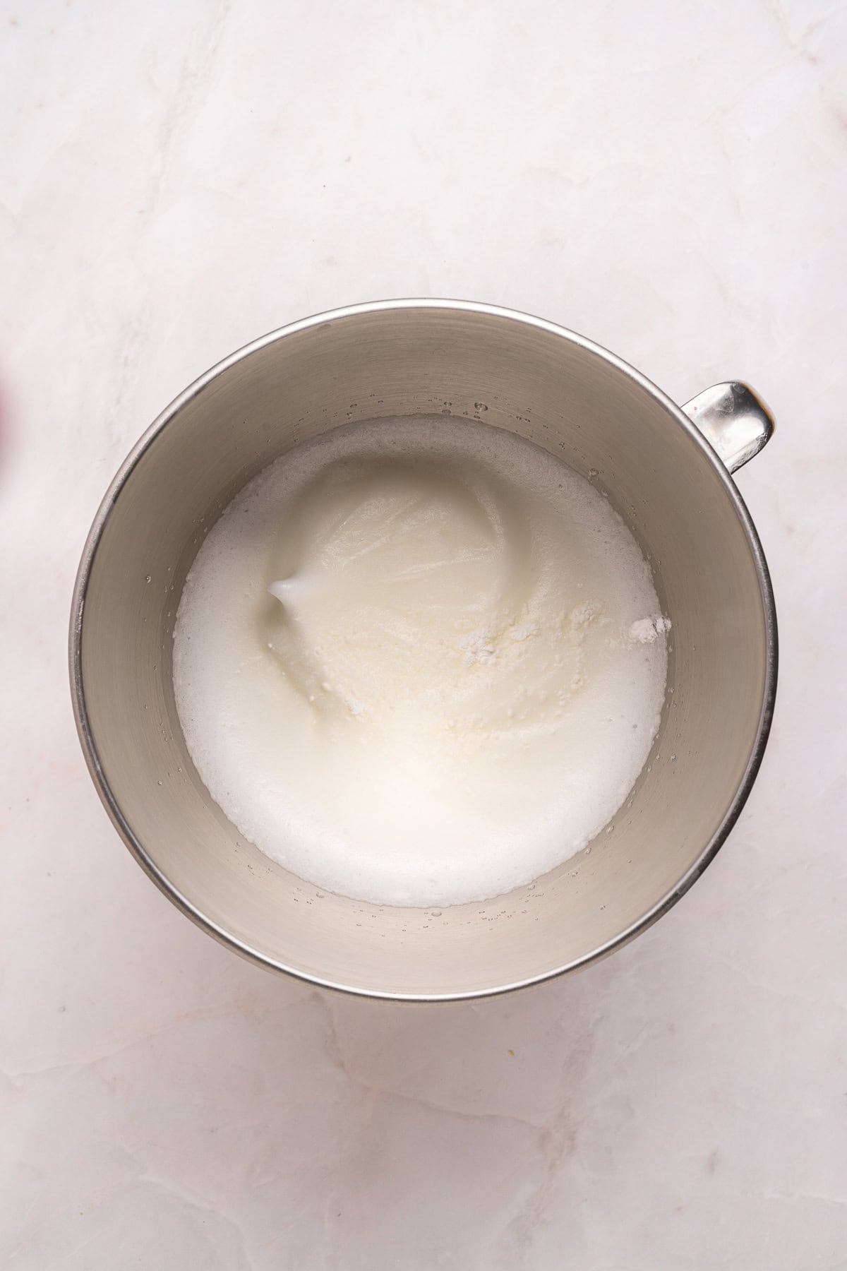 Whipping egg whites to soft peaks.