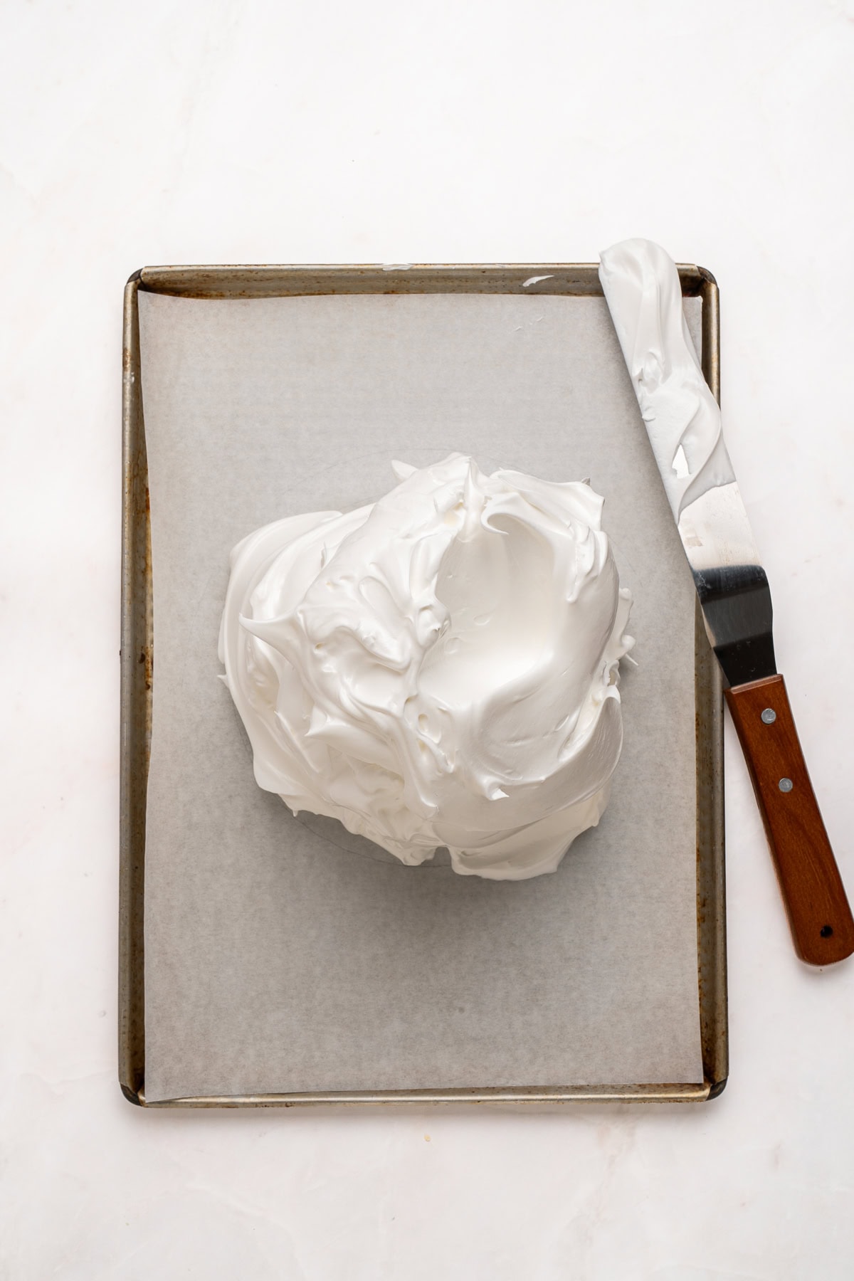 Transfering meringue to the baking sheet pan.