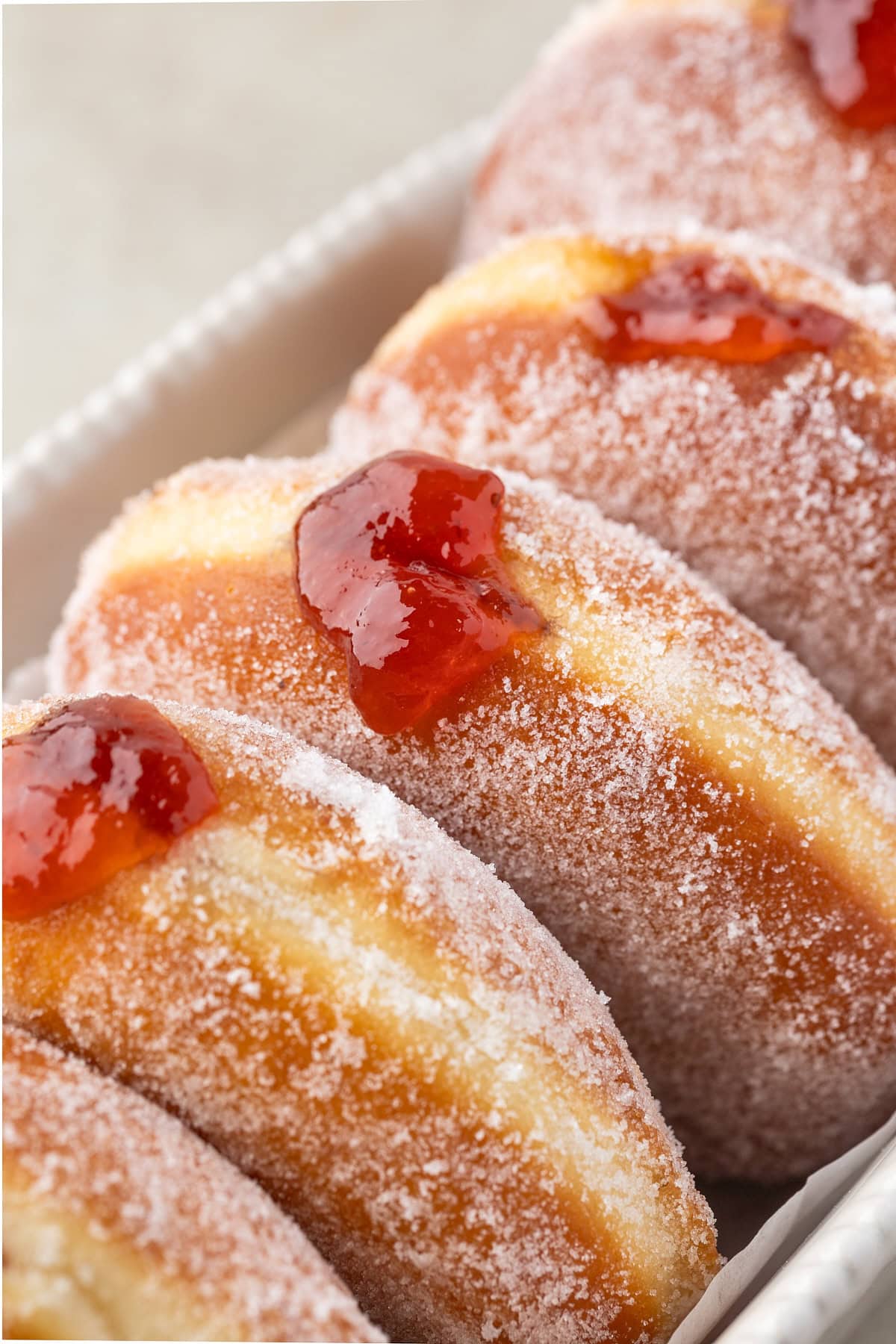 Close-up of jam coming out of a donut. 