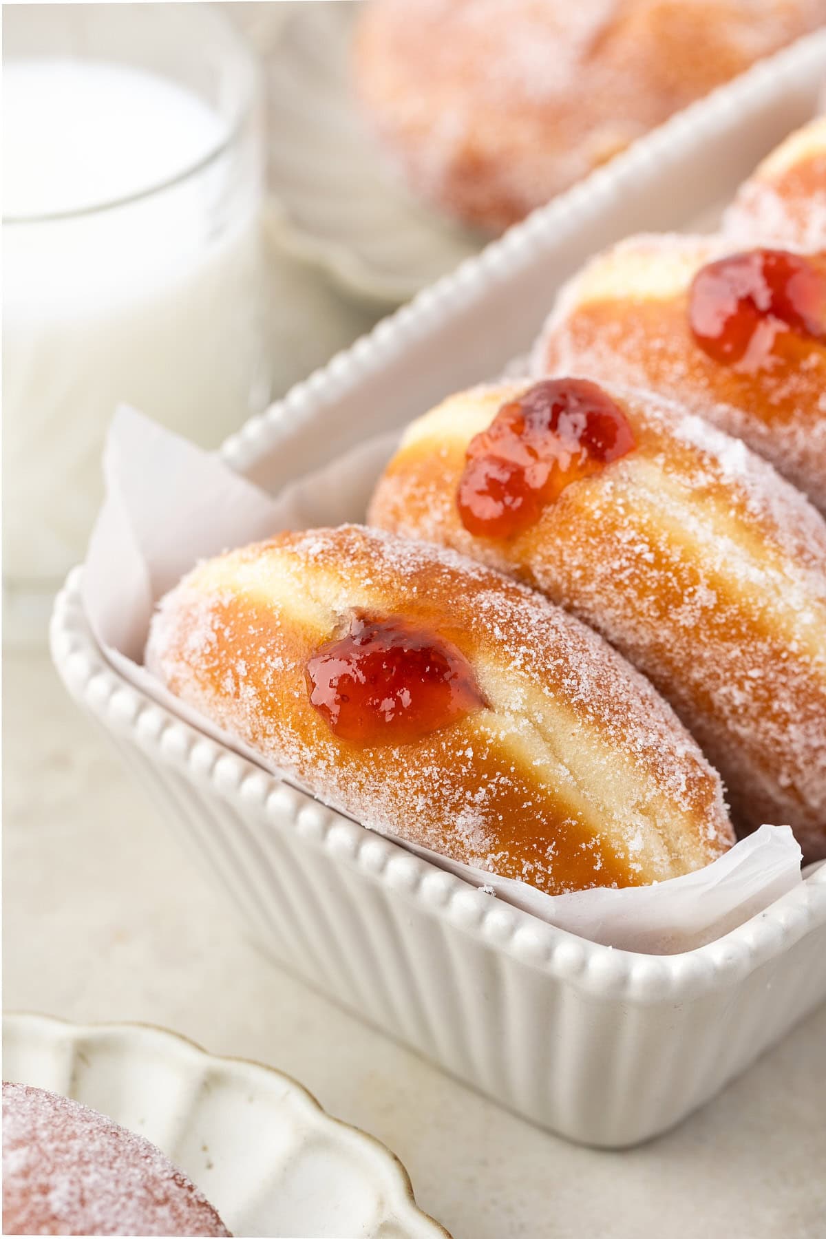 Donuts standing up in a container. 