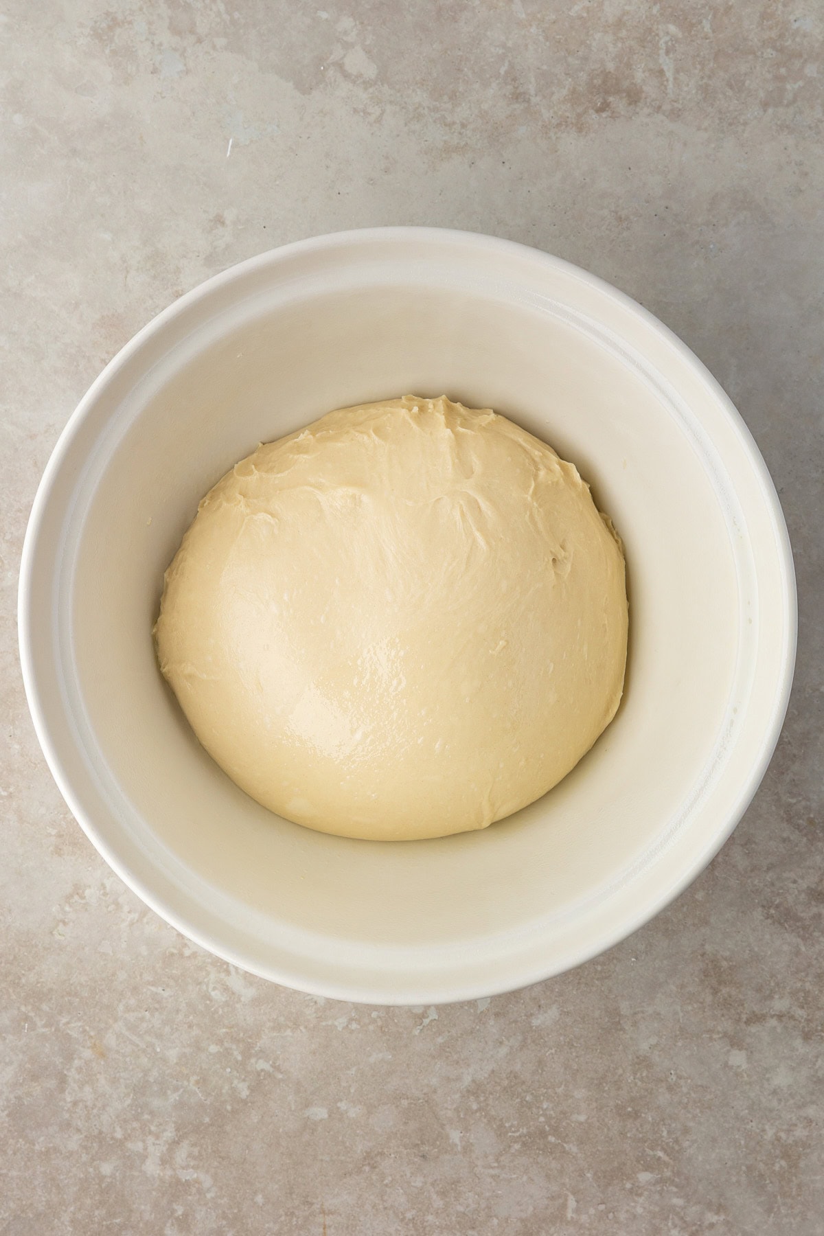 Dough added to a greased bowl. 