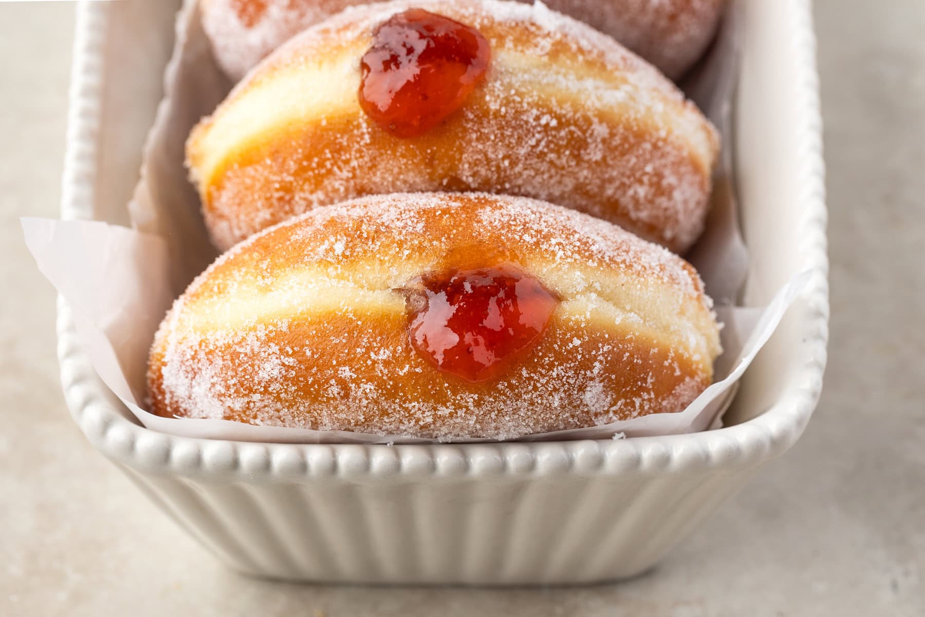 Horizontal photo of donuts in a container. 