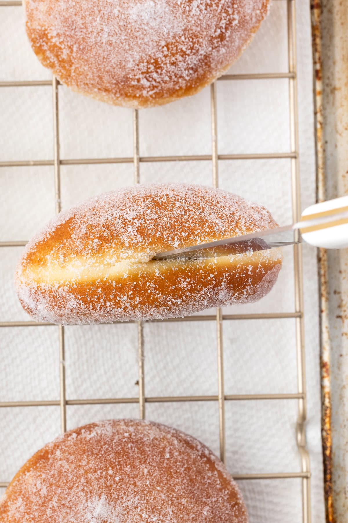 Sticking a steak knife into the donut. 