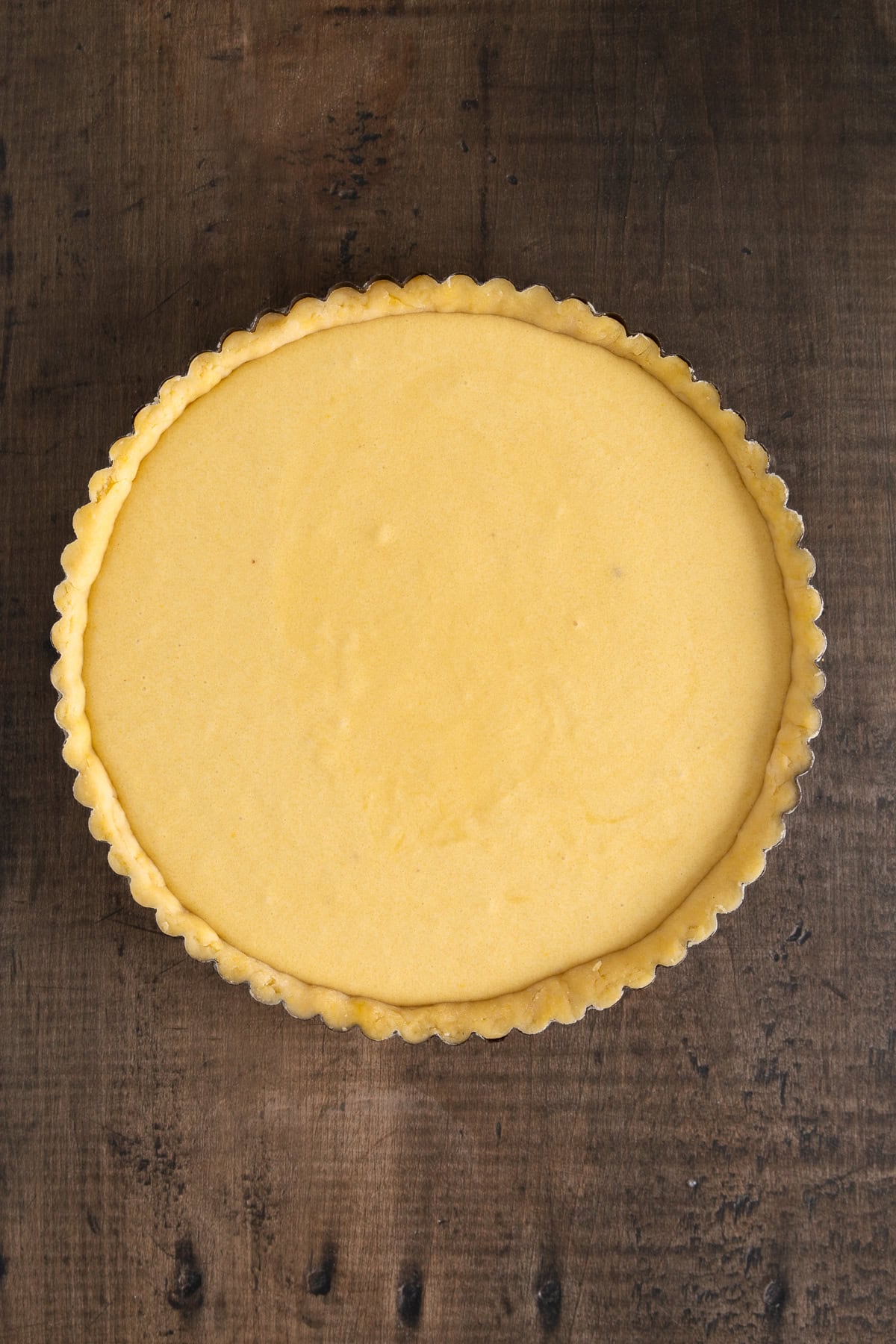 Filling added to the tart pan. 