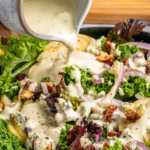 Pouring dressing on salad.