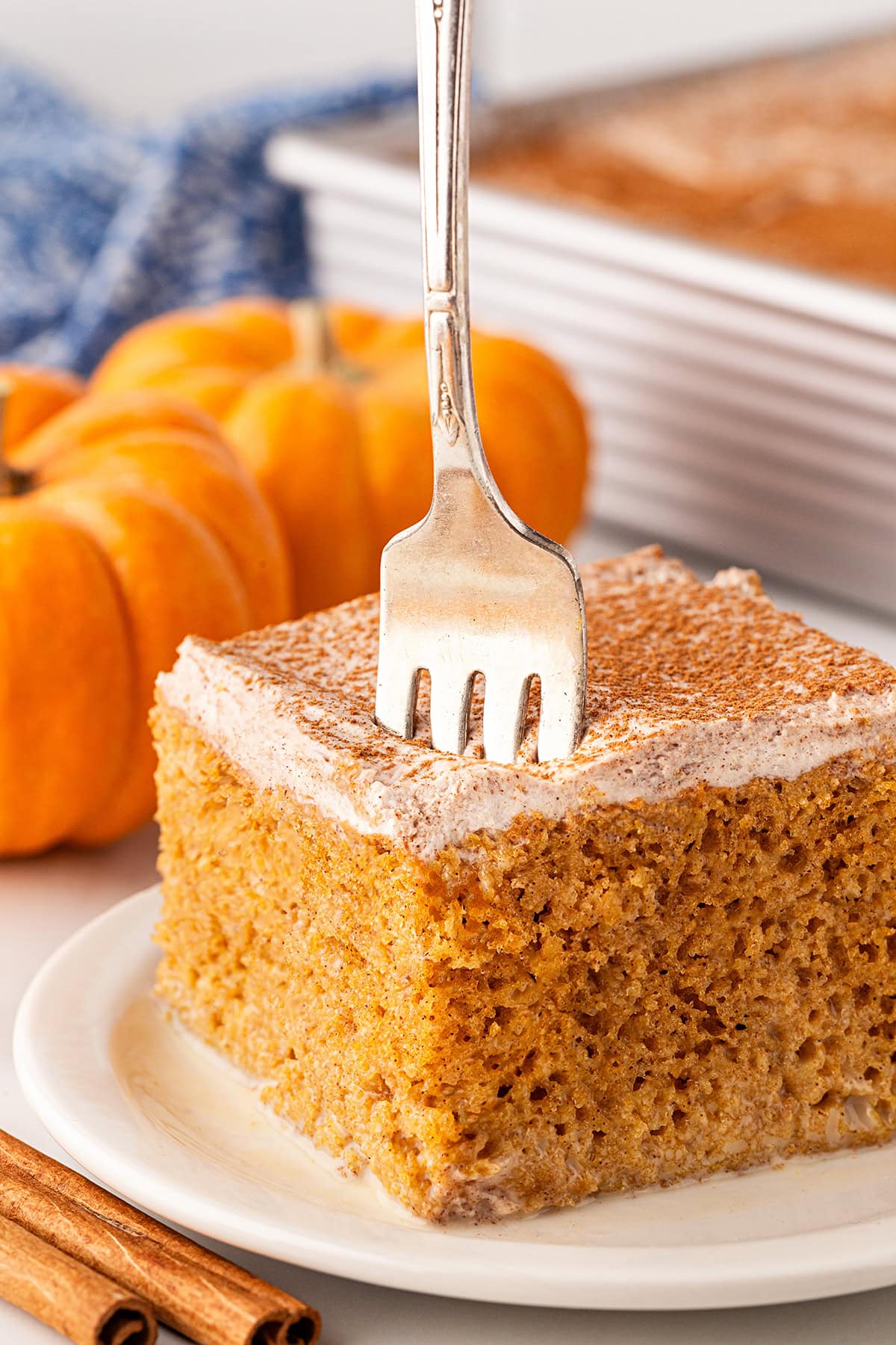 Sticking a fork into a piece of cake.