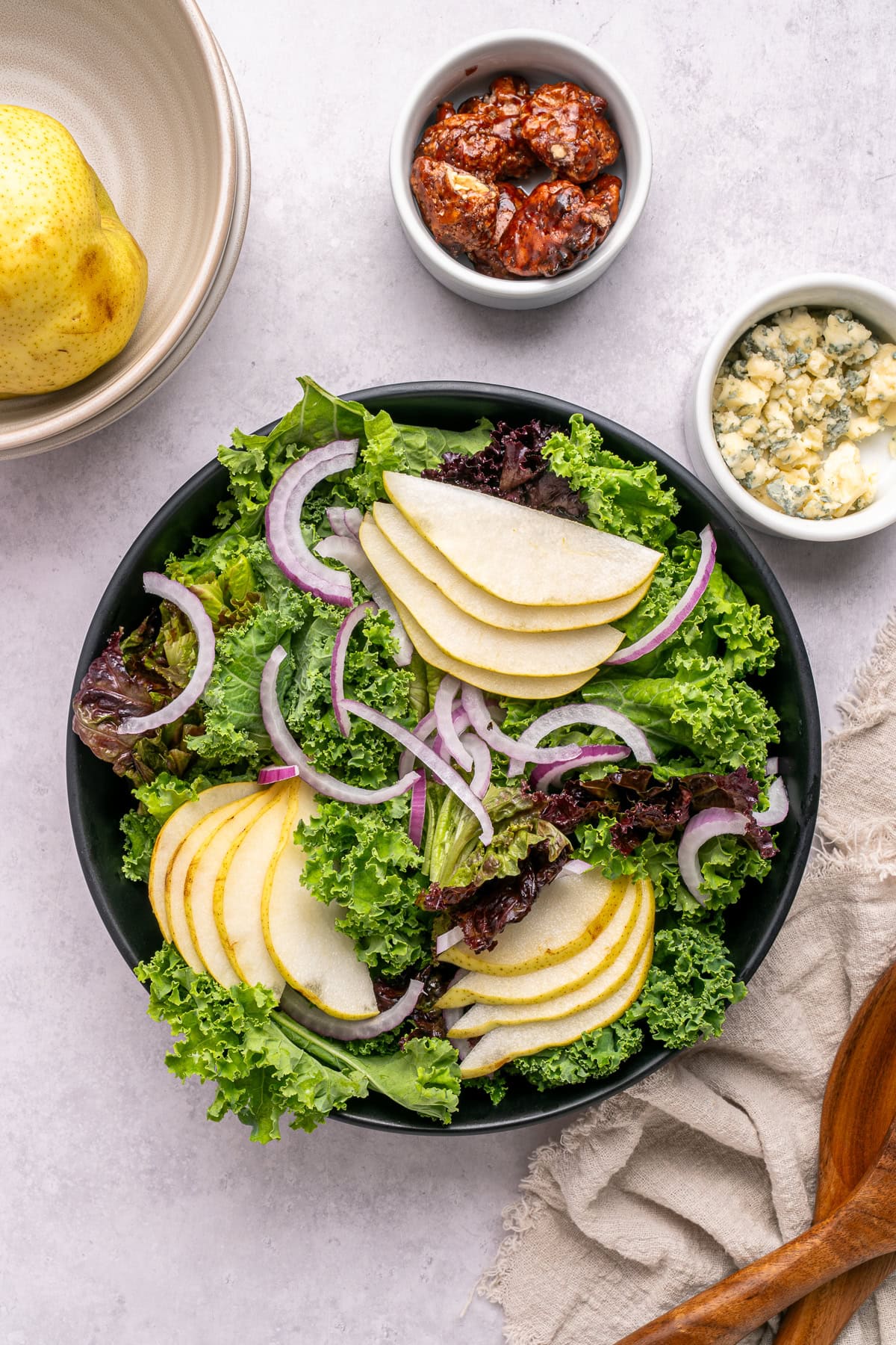 Assembly of pear and walnut salad.