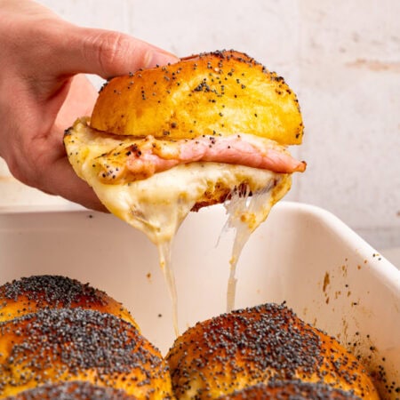 Pulling a ham and cheese sandwich out.
