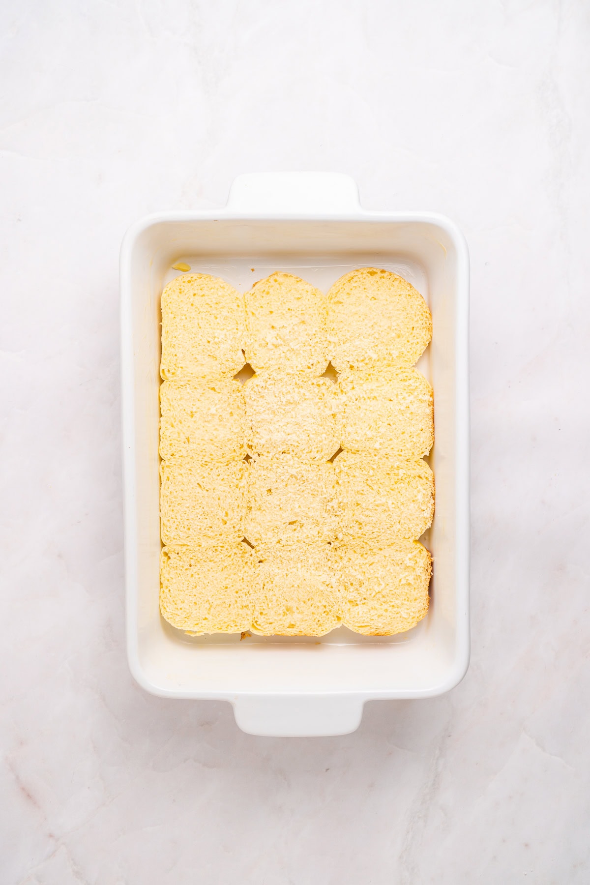 Sliced bottoms of hawaiian rolls.