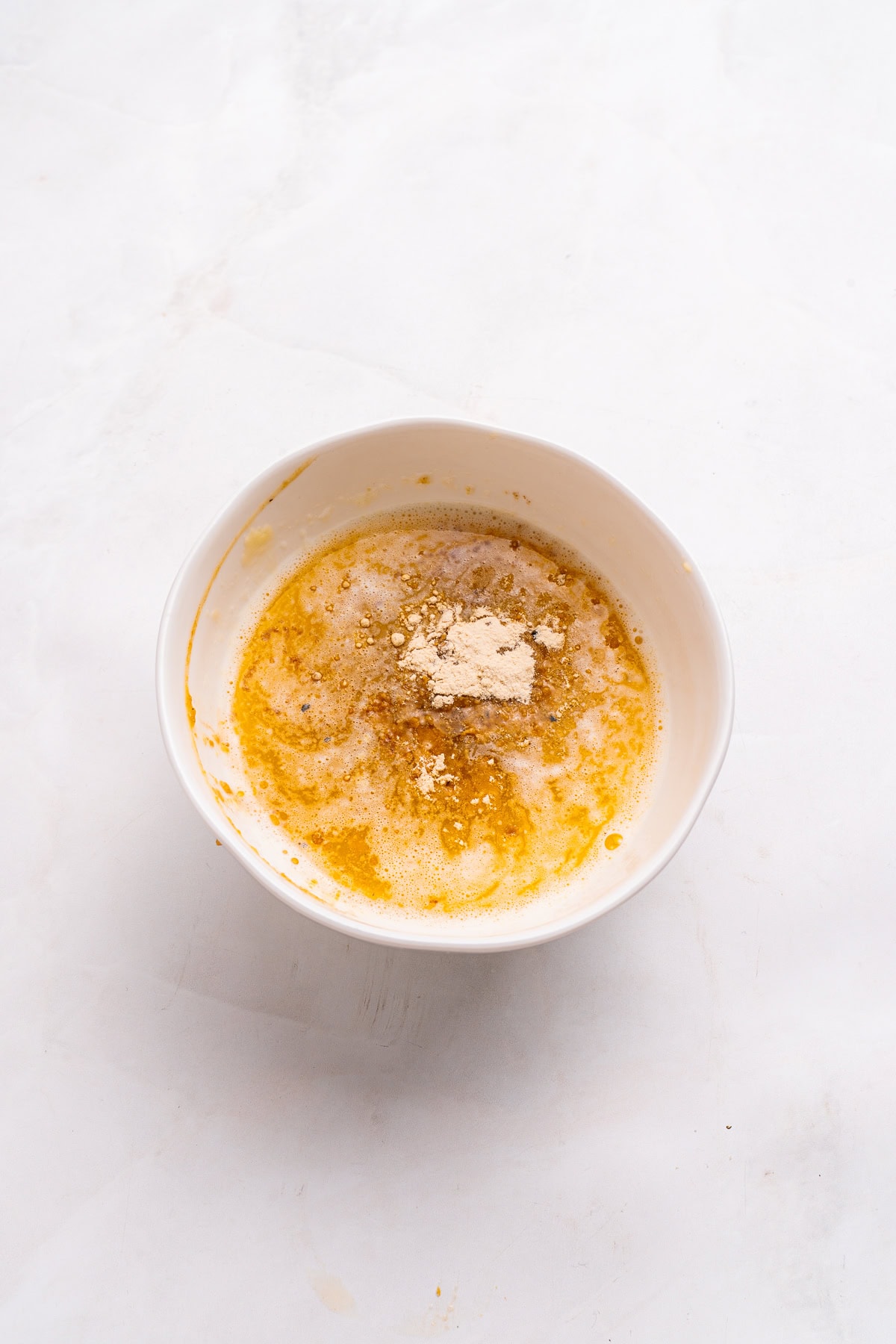 Melted butter and seasonings in a small bowl.