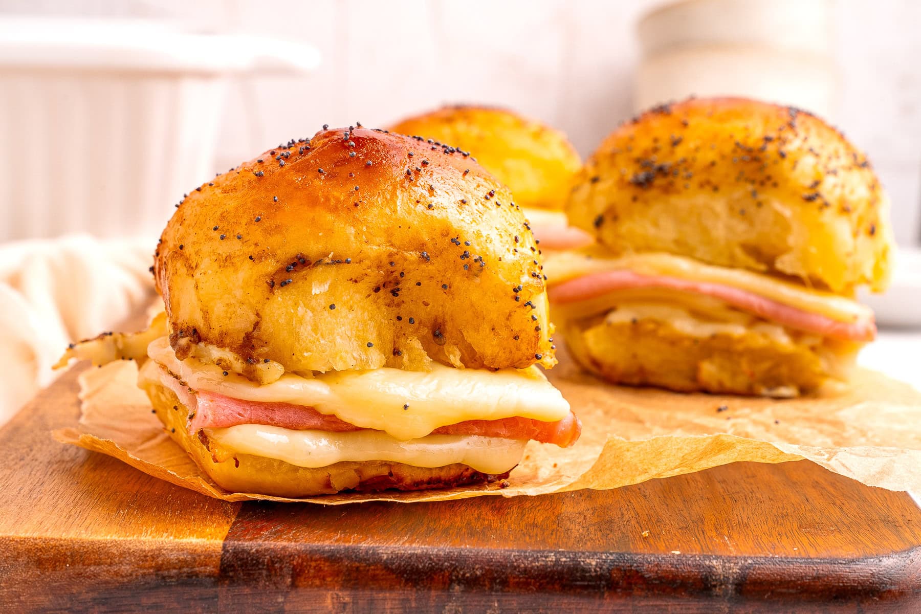 Close-up on a ham and cheese slider.
