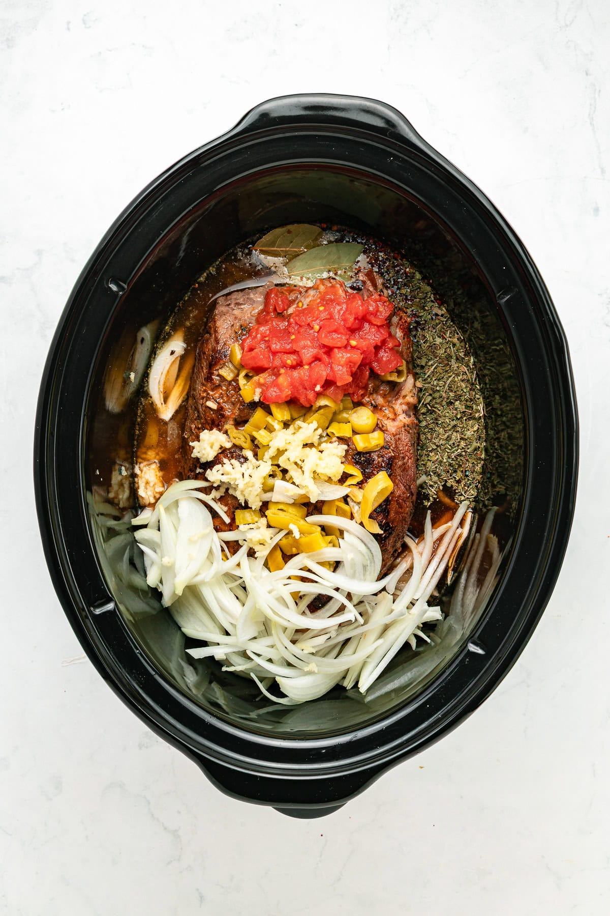 Italian beef ingredients in a slow cooker.