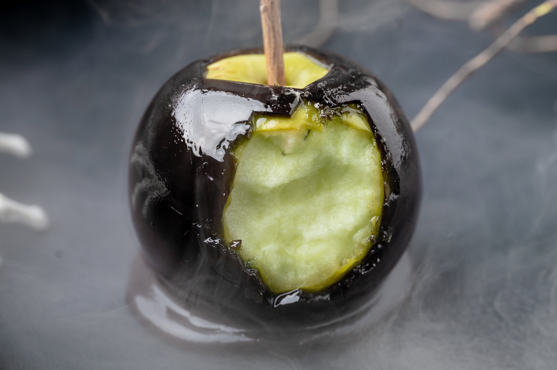 A bite taken from a candy apple. 