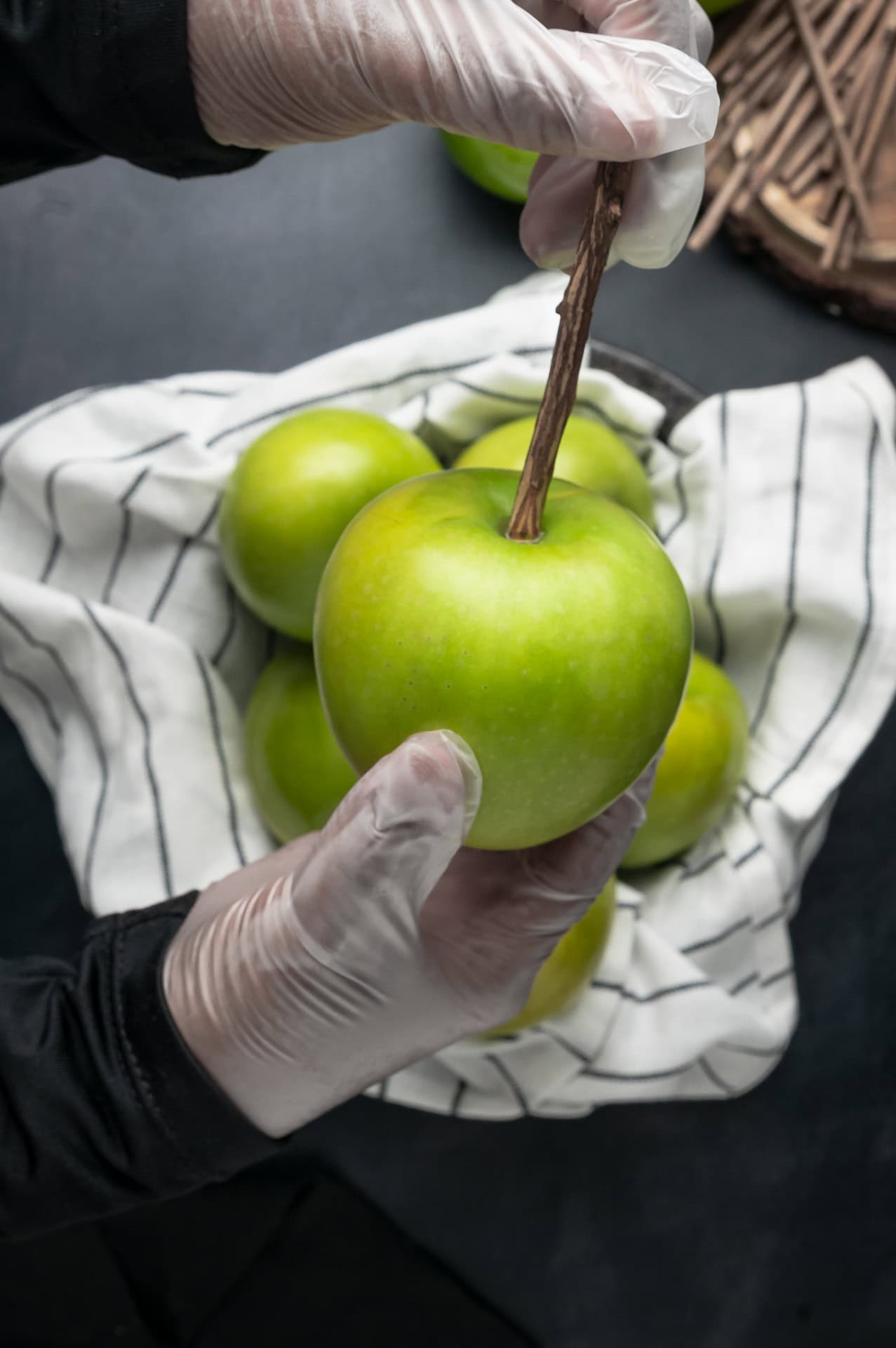 Adding sticks to apples.
