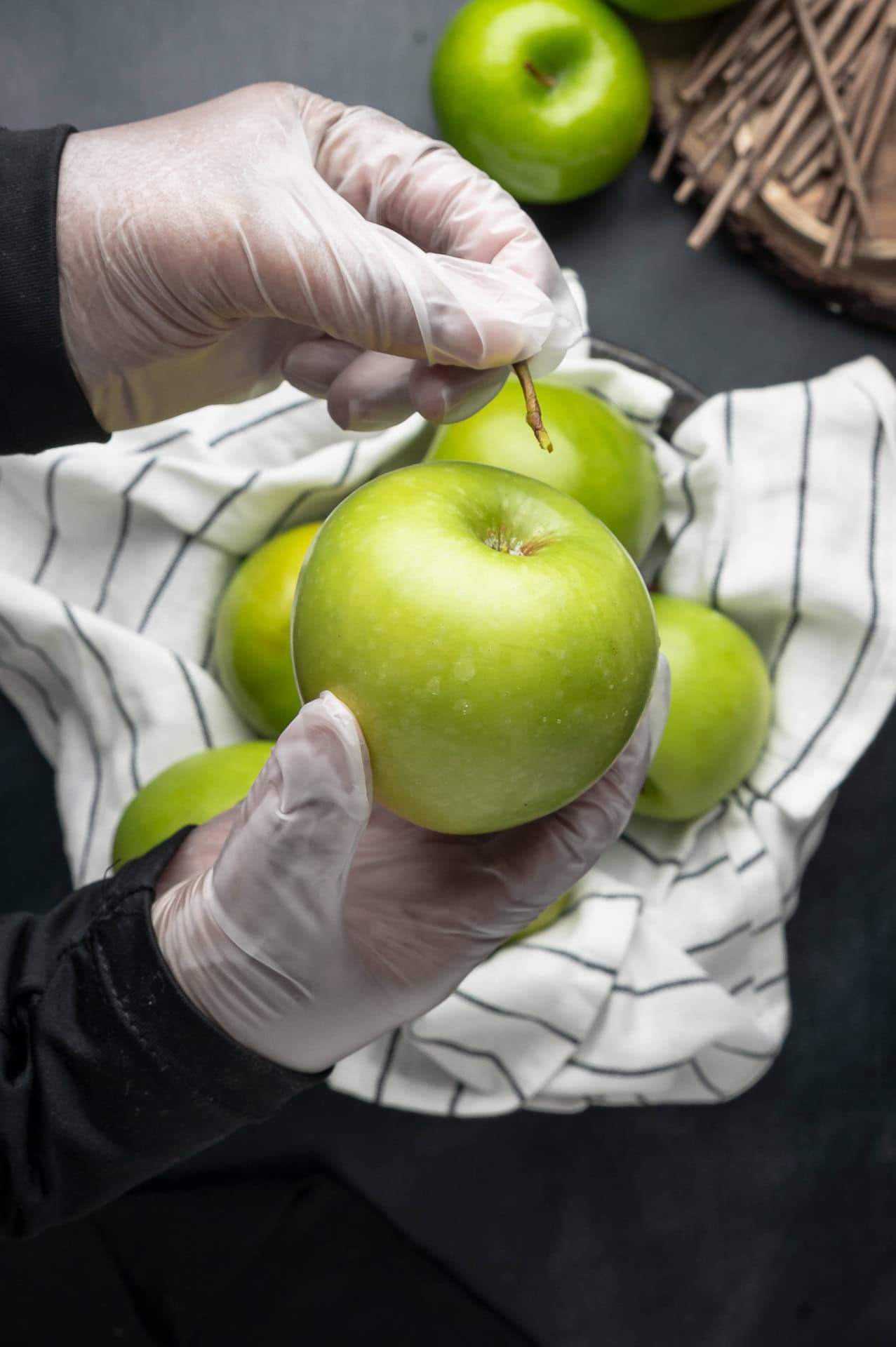 Removing stems from apples. 
