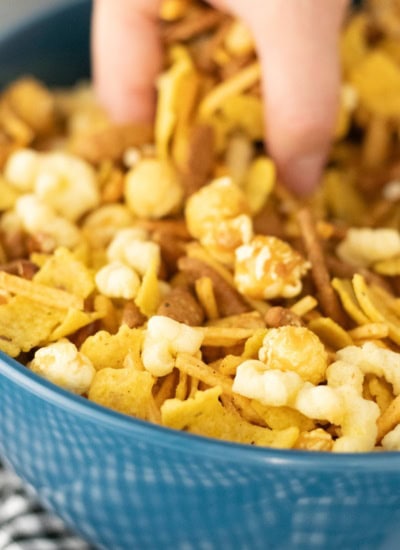 Grabbing a handful of Party Mix.