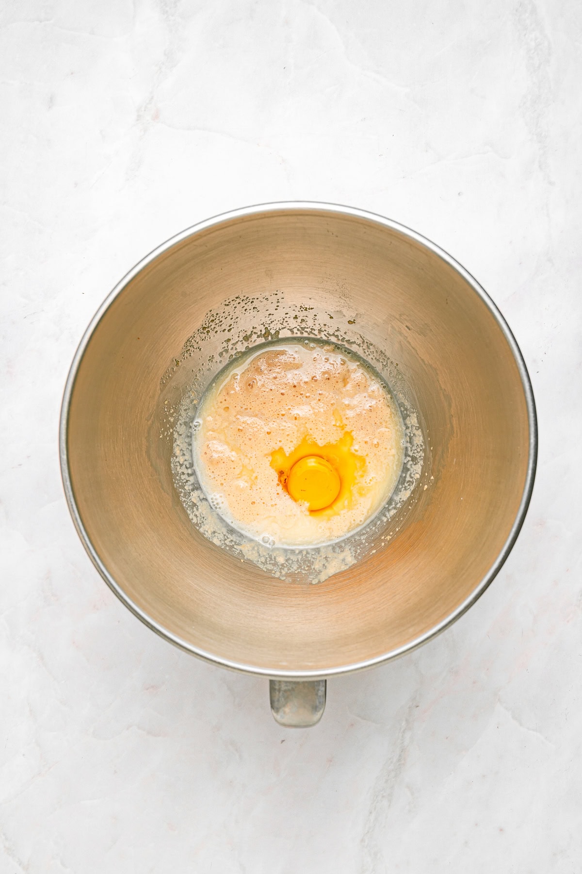 Incorporating the egg to the yeast mixture.