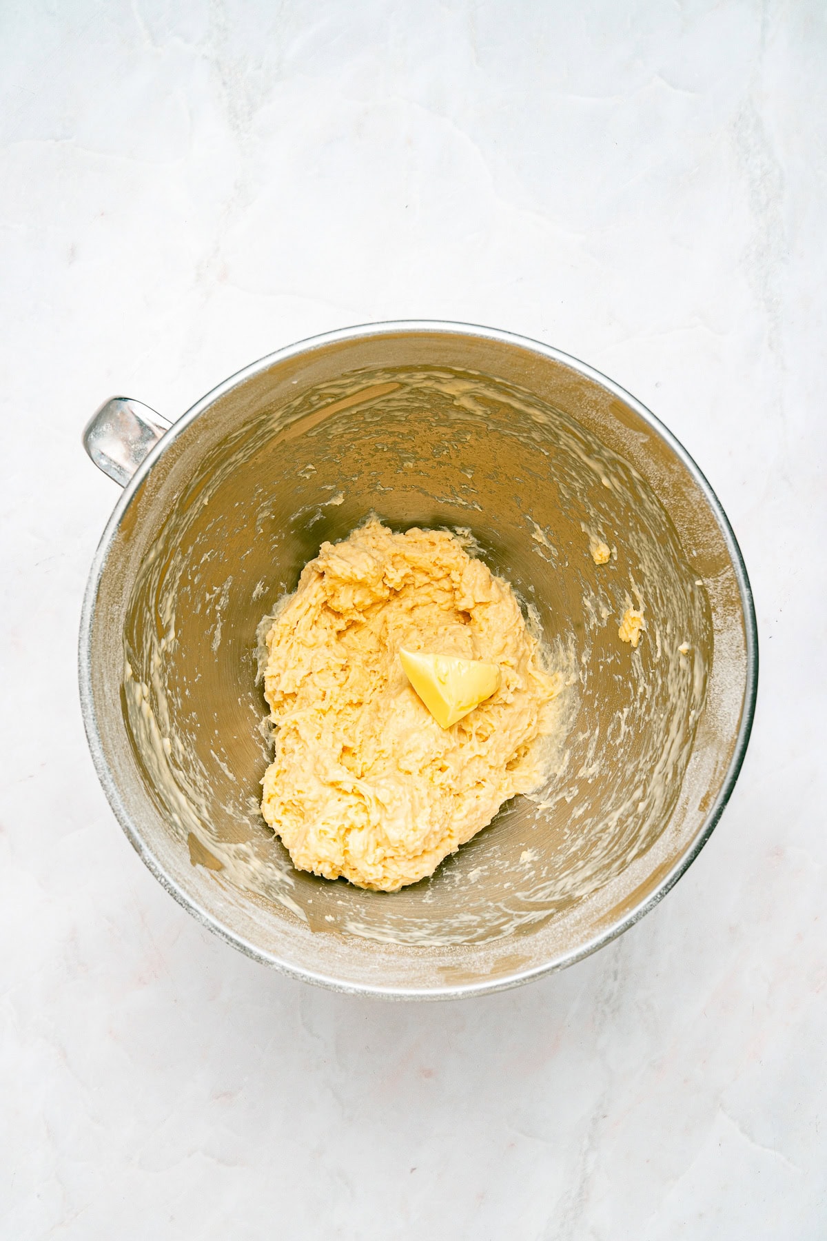 Adding butter to the dough.