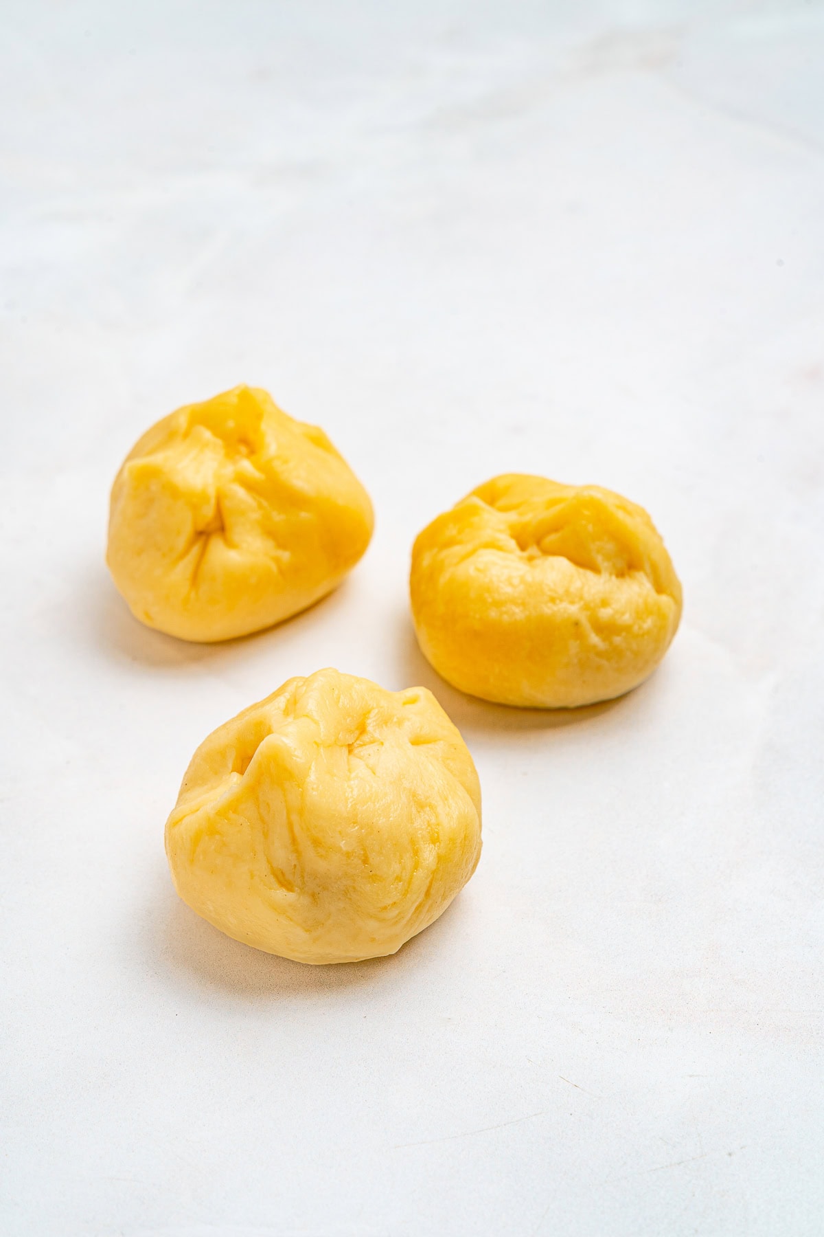 Kneading small balls of dough.