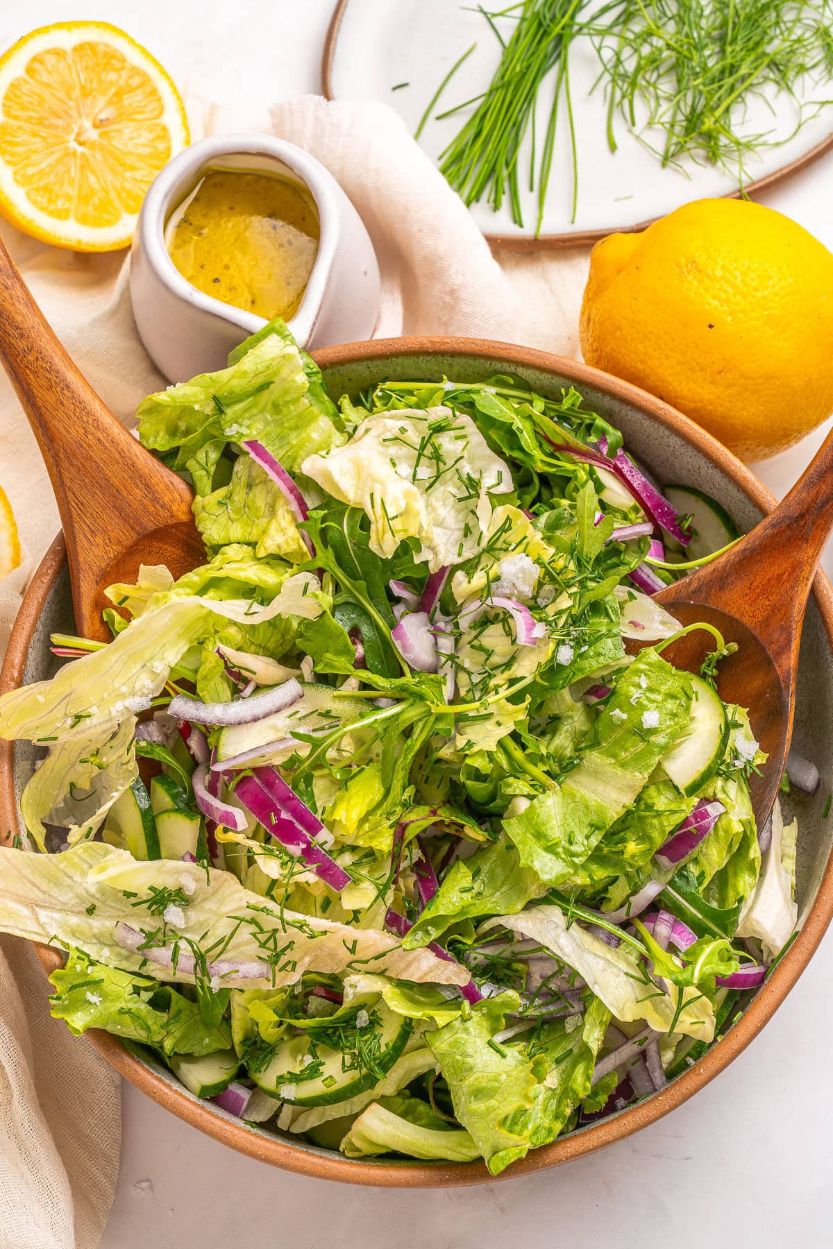 Mixing salad ingredients in a large bowl.