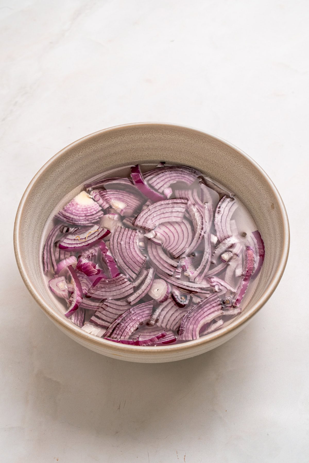 Soaking red onion in cold water.