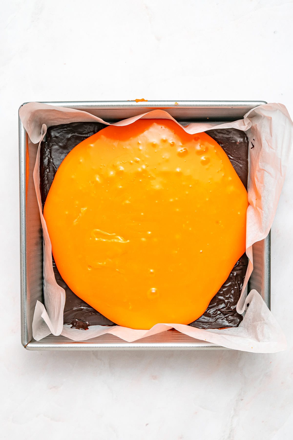 Extending orange layer over the chocolate fudge.
